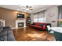 Cozy living room with a fireplace, hardwood floors, and stylish decor creating a warm atmosphere at 307 Blue Spruce Dr, Pendleton, IN 46064