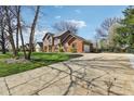 Well-maintained two-story home with attached garage, long driveway, and a large front yard at 3376 Scramble Dr, Greenwood, IN 46143