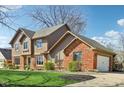 Beautiful two-story home featuring wood and brick exterior with a two car attached garage at 3376 Scramble Dr, Greenwood, IN 46143