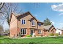 Charming two-story home with brick and wood siding, a well-manicured lawn, and inviting curb appeal at 3376 Scramble Dr, Greenwood, IN 46143