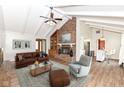 Inviting living room featuring a brick fireplace, vaulted ceilings, and hardwood floors at 406 Hickory Dr, Greenfield, IN 46140