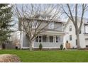 Inviting two-story home with a covered front porch and beautiful lawn at 4317 N Park Ave, Indianapolis, IN 46205