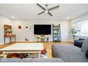 Cozy living room features hardwood floors, a large television, and comfortable seating arrangements at 5201 Radnor Rd, Indianapolis, IN 46226