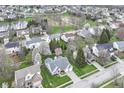 Wide aerial shot of the neighborhood, highlighting the home's location, landscaping, and community features at 5300 Breakers Way, Carmel, IN 46033