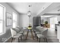 Modern dining room with a glass table and contemporary chairs at 6205 Beech Grove Rd, Martinsville, IN 46151