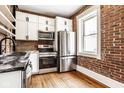 Updated kitchen with stainless steel appliances and exposed brick at 643 Fort Wayne Ave # B & D, Indianapolis, IN 46204