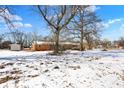 Expansive backyard in winter featuring mature trees and a storage shed at 6838 Hague Rd, Indianapolis, IN 46256