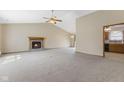 Bright living room with a brick fireplace, neutral carpet, and vaulted ceilings at 7579 Allenwood Ct, Indianapolis, IN 46268
