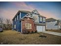 Charming two-story home with a brick and siding exterior and an attached two-car garage at 8148 Ebaugh Dr, Camby, IN 46113