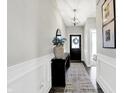 Inviting hallway features a decorative mirror, stylish runner rug, and modern light fixture at 8148 Ebaugh Dr, Camby, IN 46113
