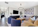 Bright living room with ample seating, modern lighting, and seamless flow to entry way at 8148 Ebaugh Dr, Camby, IN 46113