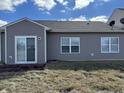 Backyard featuring sliding glass doors to a brick patio and view of the yard at 8412 Pippen Pl, Camby, IN 46113