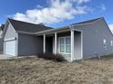 One-story home showcasing a welcoming covered entry and tidy front yard at 8412 Pippen Pl, Camby, IN 46113