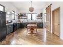 Open kitchen and dining area featuring dark green cabinets and wood countertops at 910 Keystone Ave, Indianapolis, IN 46201