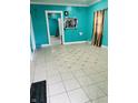 Turquoise living room highlighting patterned tile flooring and views into the next room at 945 N Ewing St, Indianapolis, IN 46201