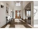 Bright foyer featuring hardwood floors, large windows, statement lighting and elegant staircase at 11573 Bent Tree Ct, Zionsville, IN 46077
