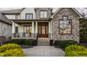 Close-up of front exterior with a beautiful door and meticulously landscaped entry way at 11573 Bent Tree Ct, Zionsville, IN 46077