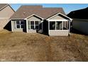 Back exterior features a screened porch, complemented by large windows and neutral siding at 1223 Blackthorne S Trl, Plainfield, IN 46168