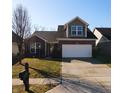 Inviting single-Gathering home featuring a two-car garage, well-kept lawn, and a mailbox with address at 1223 Blackthorne S Trl, Plainfield, IN 46168