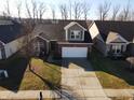 Aerial view of a single-Gathering home boasting a two-car garage, surrounded by a well-maintained lawn at 1223 Blackthorne S Trl, Plainfield, IN 46168