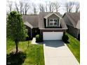 Inviting home showcasing well-kept lawn, mature trees, and a classic brick and siding facade at 1223 Blackthorne S Trl, Plainfield, IN 46168