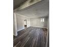Bright living room with wood-look flooring, fresh paint, and windows providing plenty of natural light at 123 S Butler Ave, Indianapolis, IN 46219