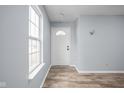 Bright entryway with wood-look flooring and a white front door at 13332 N Brick Chapel Dr, Camby, IN 46113