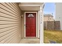 Close-up of a red front door with decorative glass and visible house number at 13332 N Brick Chapel Dr, Camby, IN 46113