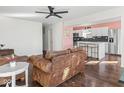 Bright living space with hardwood floors, a ceiling fan, and an open view into the kitchen at 1420 E Market St, Indianapolis, IN 46201