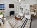 Bright living room with fireplace, neutral color scheme, and contemporary furnishings at 1535 Arbor Springs Dr, Brownsburg, IN 46112