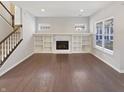 Spacious living room showcasing hardwood floors, fireplace, and ample natural light at 1670 Rossmay Dr, Westfield, IN 46074