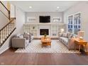 Bright living room with a fireplace, built-in shelving, and neutral-toned furniture at 1670 Rossmay Dr, Westfield, IN 46074