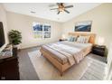 Cozy bedroom with a ceiling fan, large window, and plush carpet at 170 Trails End, Brownsburg, IN 46112