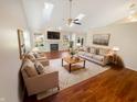 Bright living room with hardwood floors, fireplace, skylights, and neutral furniture at 170 Trails End, Brownsburg, IN 46112