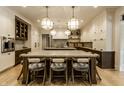 Bright kitchen boasts a large center island with seating, stylish pendant lighting, and premium stainless appliances at 1813 Milford St, Carmel, IN 46032