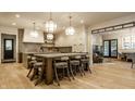 Well-appointed kitchen featuring a large island with seating and stylish pendant lighting, and open concept design at 1813 Milford St, Carmel, IN 46032