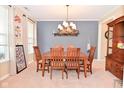 Cozy dining room with classic chandelier and decorative elements, next to large windows at 1905 Windsor Ln, Danville, IN 46122