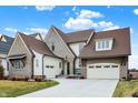 Stunning exterior featuring a circular driveway and attached garage for convenient parking at 19795 Chatham Shore Ln, Westfield, IN 46074