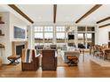 Elegant living room with a fireplace, hardwood floors, and large windows offering scenic views at 19795 Chatham Shore Ln, Westfield, IN 46074