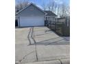 Charming single-story home with gray siding and an attached garage, on a concrete driveway at 2027 E Werges Ave, Indianapolis, IN 46237