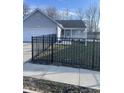 Charming single-story home with gray siding, a black metal fence and well-maintained lawn at 2027 E Werges Ave, Indianapolis, IN 46237