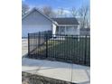 Charming single-story home with gray siding, a black metal fence and well-maintained lawn at 2027 E Werges Ave, Indianapolis, IN 46237