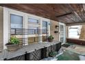 Inviting covered front porch featuring a decorative railing, wood ceiling, and a 'Welcome' mat at 2401 N Olney St, Indianapolis, IN 46218