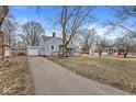 Exterior view of a single Gathering home with a detached garage and driveway at 2420 Sheffield Ave, Anderson, IN 46011