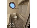 Cozy bathroom with a classic bathtub and unique octagon-shaped window at 3209 Bethel Ave, Indianapolis, IN 46203