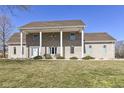 Classic brick home with charming covered entryway, lush lawn and beautifully landscaped front yard at 3332 W Raven Field Blvd, Greenfield, IN 46140