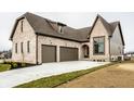 Beautiful brick home featuring an attached two car garage, arched front door, and newly seeded lawn at 3588 Marketplace Ct, Zionsville, IN 46077