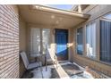 Inviting front porch with seating area, a vibrant blue door, and ample natural light at 3636 Woodglen Way, Anderson, IN 46011