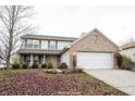 Charming two-story home with a brick facade and attached two-car garage on a lot covered with leaves at 436 N Shore Ct, Franklin, IN 46131