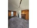 Living room featuring hardwood floors, wood paneled walls, and a fireplace at 439 N Colorado Ave, Indianapolis, IN 46201